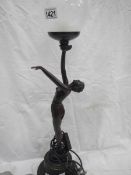 A table lamp with naked lady figure