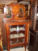 A fine mahogany art nouveau cabinet with lead glazed door