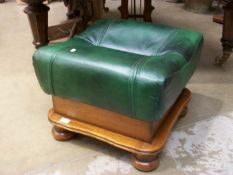 A green leather topped large foot stool