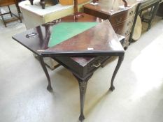 An Edwardian mahogany envelope card table with drawer