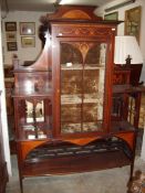 An Edwardian inlaid cabinet with central glazed door and velvet lined interior