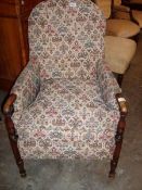 An Edwardian arm chair with tapestry upholstery