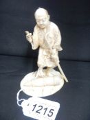 A signed ivory Okimono of farmer with staff