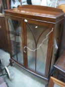 A 1930's oak 2 door display cabinet (glass missing from right side)