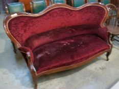 A Victorian mahogany framed plush velvet settee