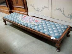 A tapestry covered long oak foot stool