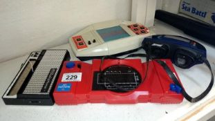 3 retro hand held computer games and a stylophone