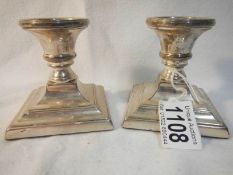 A pair of silver candlesticks,