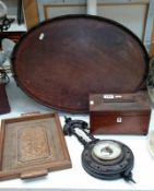 A rosewood tea caddy, an ebonised barometer,