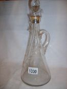 An early 20th century wine carafe with silver top,