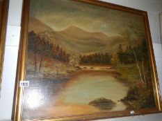 An original oil on canvas lake and mountain scene, initialed and dated GG '25?,