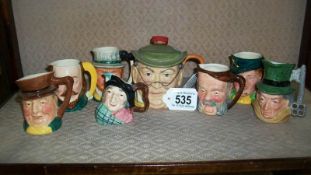 7 small character jugs and a scarce Mr Pickwick spirit flask