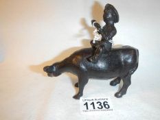 A Chinese bronze of a figure on a water buffalo