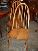 A set of 4 Ercol stick and hoop back chairs