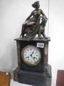 A black marble mantel clock surmounted figure