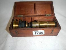 A 19th century microscope in wooden case,