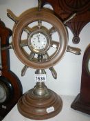 An unusual mantel clock on ship's wheel and capstan stand