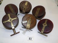 5 vintage wooden spine back reels and a star back reel