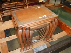 A nest of 3 teak tables with carved edge to top and Queen Anne style legs