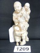 An ivory Okimono of a man with children