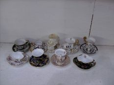 8 miniature cups and saucers and a Carlton ware crested  Toby jug