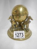 A super small Regency brass inkwell with 3 dogs supporting globe