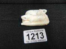 An ivory netsuke of rats on corn cob,