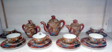 A 21 piece Oriental tea service (Geisha portrait) (1 spout a/f)