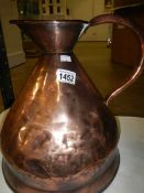A 2 gallon copper jug with brass marking for J Newman,