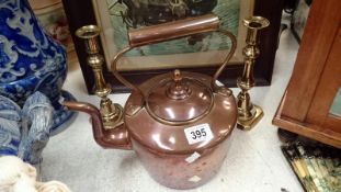 A Victorian copper kettle and a pair of Victorian brass candlesticks