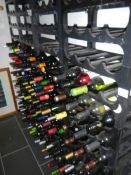 2 large racks with approximately 130 bottles of wine etc