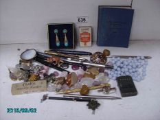 An interesting box of miscellaneous items including pens, lighter, stones, curios,