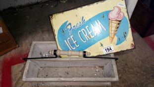 A retro metal ice cream sign and a painted wooden cutlery tray