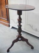 A Victorian tripod wine table