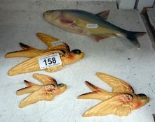 A set of 3 pottery flying ducks and a Dutch ceramic fish