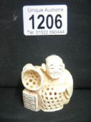 A signed ivory netsuke of a basket maker