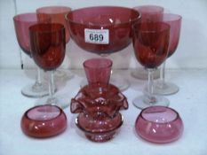 A quantity of cranberry glass items