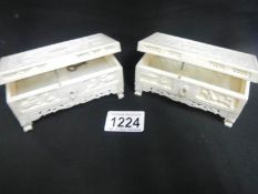 A pair of carved bone caskets,