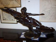 An art nouveau style spelter figure of a reclining naked lady