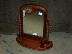 A stained mahogany toilet mirror