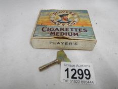 A 1950's clockwork vibrating Player's Navy Cut cigarette box