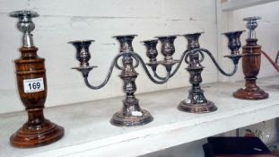 A silver plated candelabra and a pair of wooden candlesticks