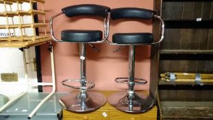 A pair of chromed adjustable high chairs