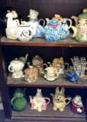 A large quantity of novelty teapots (3 shelves)