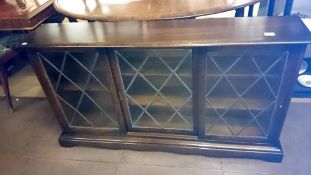 An oak bookcase with leaded glass doors
