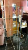 A glass & chrome shelf unit