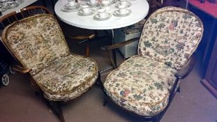 A pair of wooden chairs with cushioned seat & back