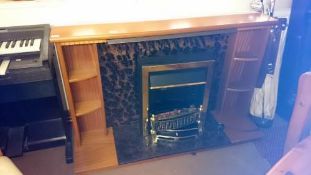 A coal effect electric fire with surround