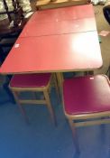 A red kitchen table & 2 matching stools