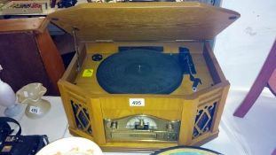 A vintage style wood cased record player with radio & cd player